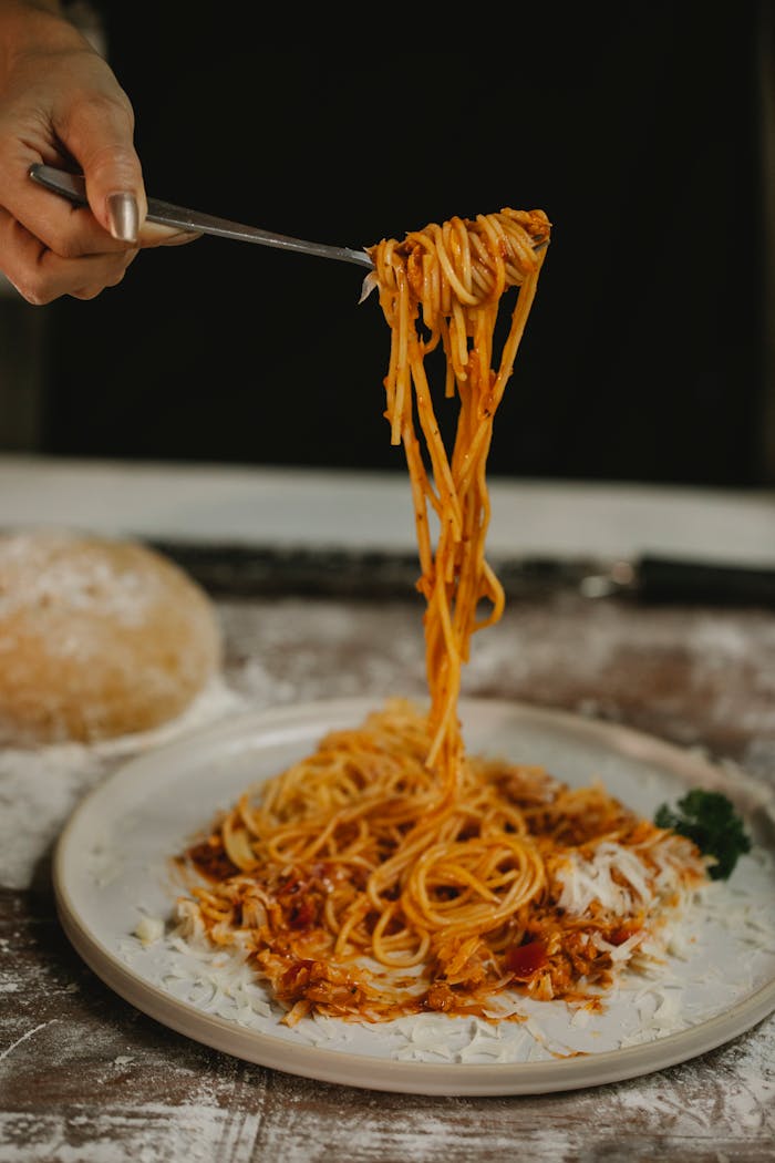 A tempting plate of homemade spaghetti bolognese with fresh ingredients and herbs.